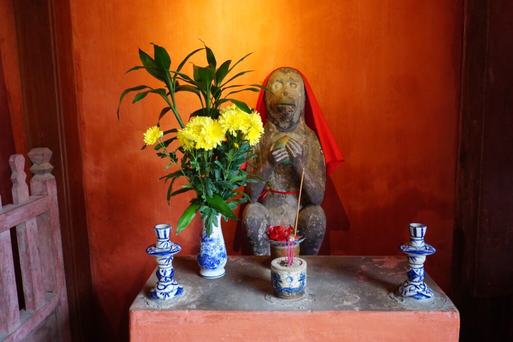 Statue eines Affen, die den Eingang zur japanischen Brücke in Hoi An bewacht.